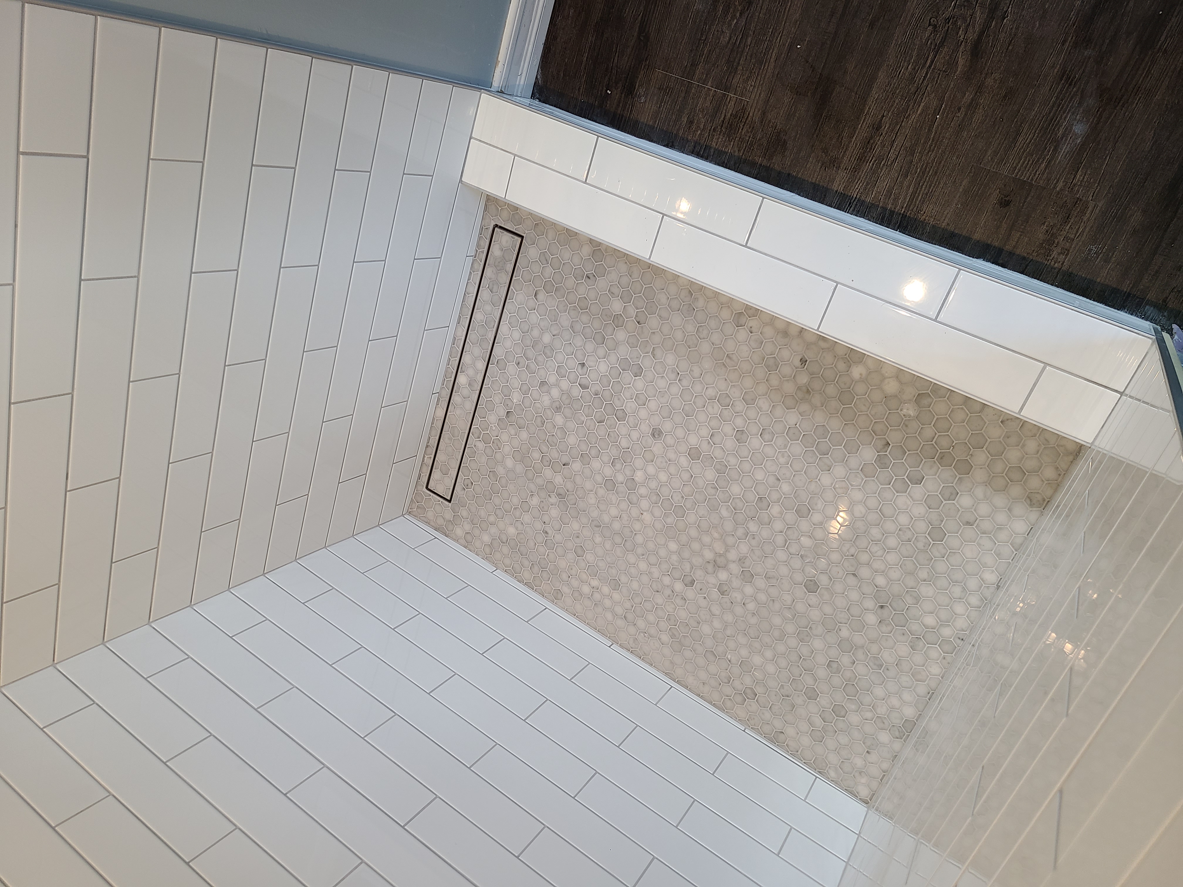 Detailed shower floor tile installation with linear drain