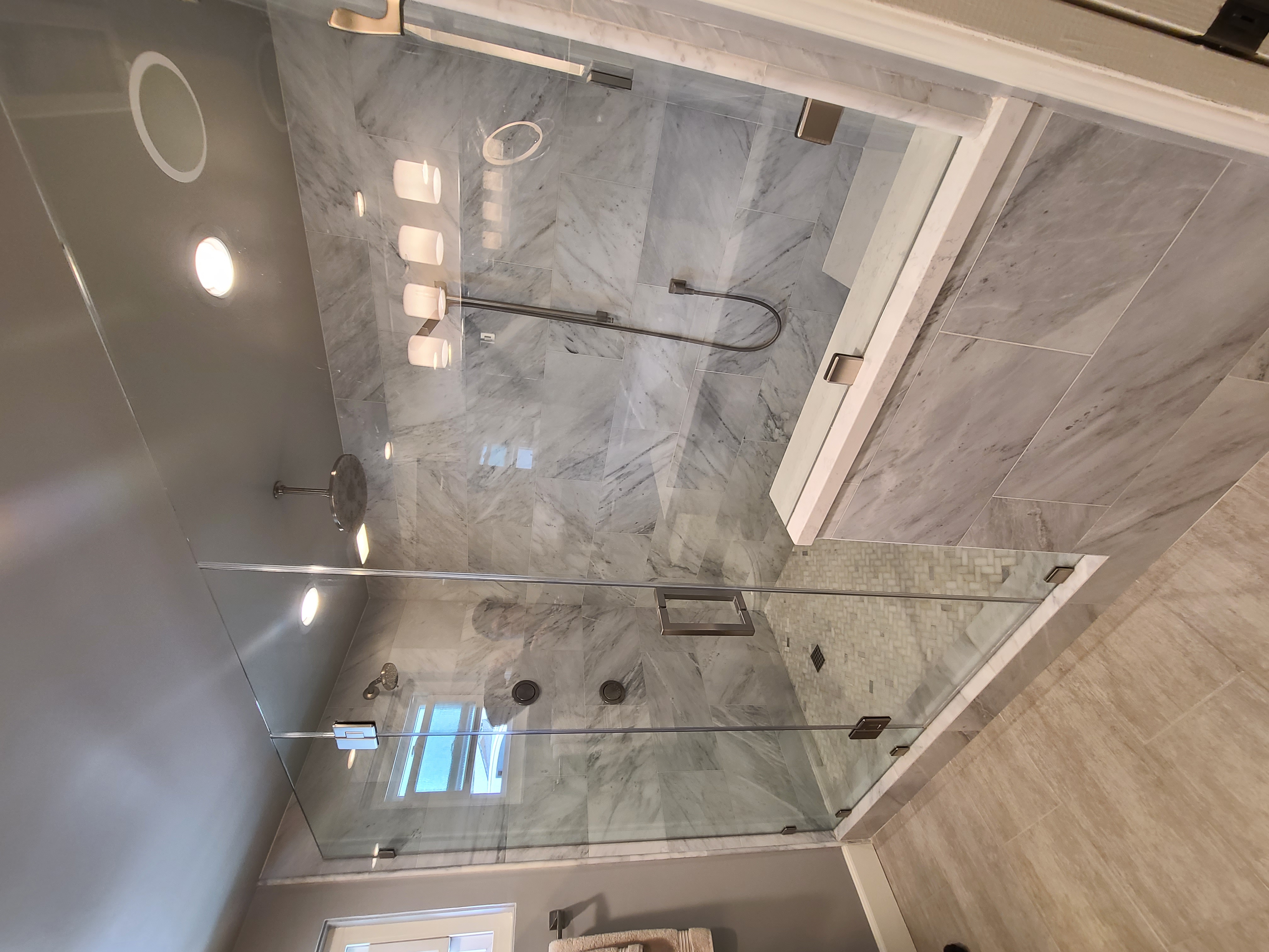Completed custom glass shower with detailed tilework