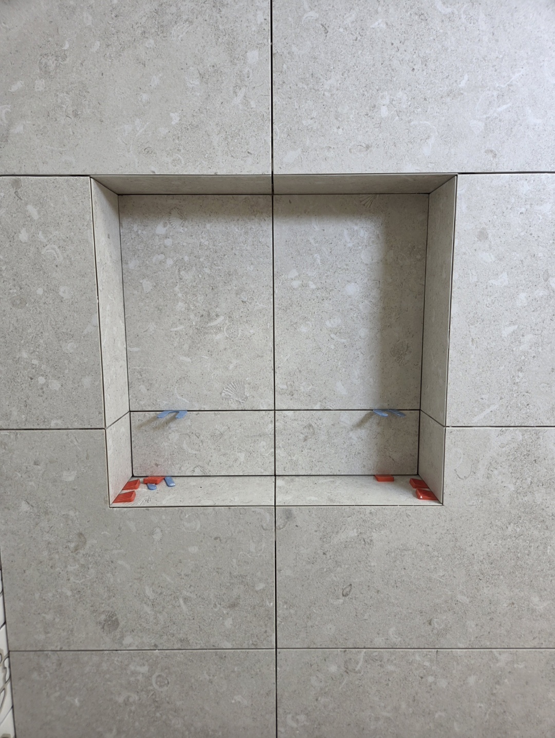 Close-up of a tiled recessed shower niche