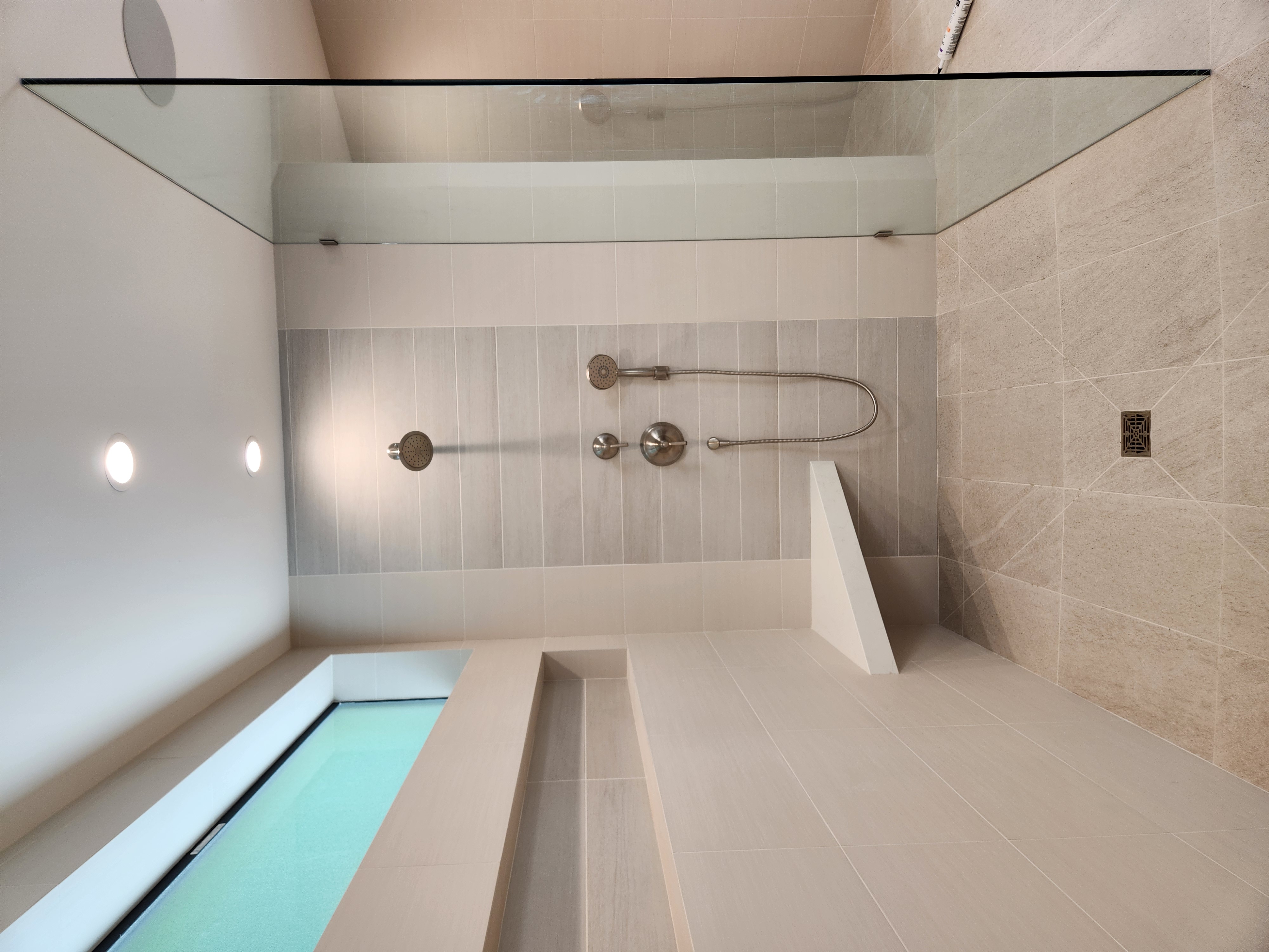 Completed walk-in shower with tiled bench and niche