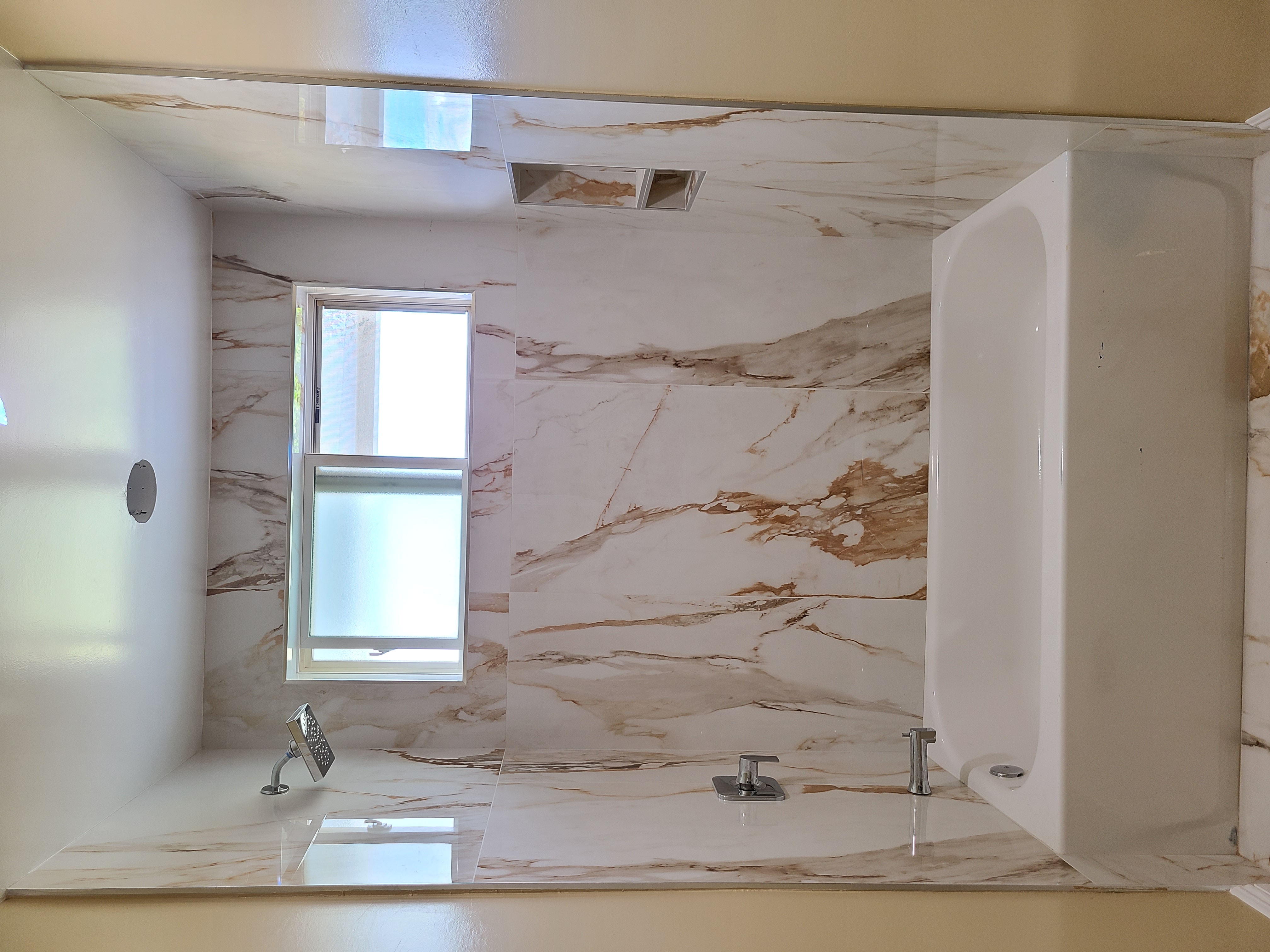 Modern completed bathroom with tub and tiled shower surround